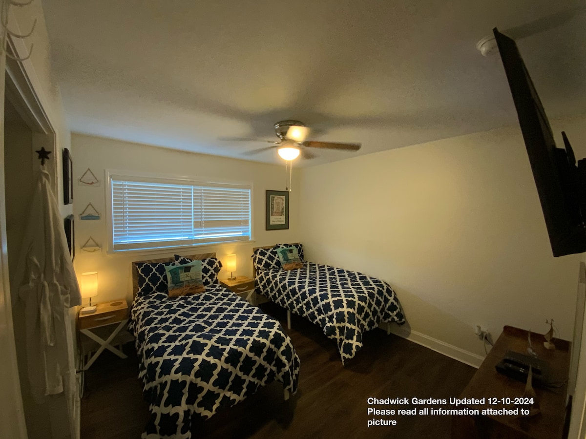 2 twin Beds, dresser, 65” smart LG TV, luggage racks, 52” ceiling fan, and original art work. .