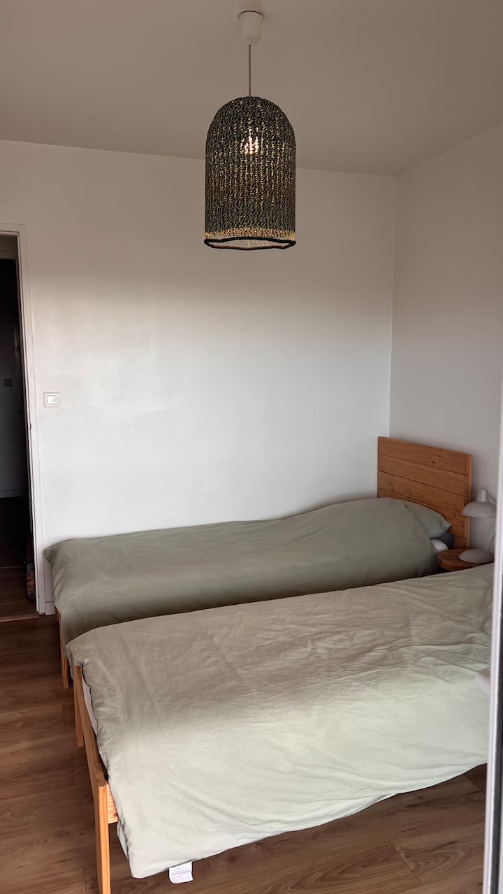 2. spálňa s 2 samostatnými lôžkami (80 x 200 cm). Krásna kompozícia v odtieňoch pieskovej a sivozelenej. Priamy prístup na krásny drevený balkón! Výhľad na dunu A slávny maják Contis.