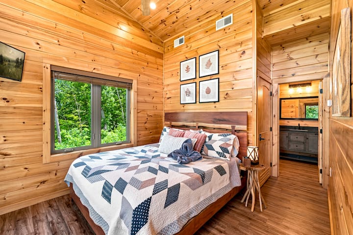The luxurious king bedroom (upstairs) has lofted ceilings, an ensuite bathroom, and a closet in the bathroom for clothing storage. Walk out onto a private upper deck to enjoy the mountain view!
