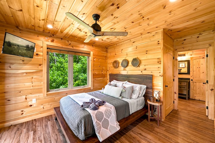 The queen bedroom (main floor) has large windows, direct access to the shared main floor bathroom, and a closet with a washer, dryer, and ironing board available for you to use. A small dresser is also provided for clothing storage.