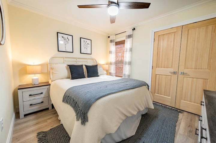 Cozy bedroom retreat with warm lighting, soft bedding, and modern décor.