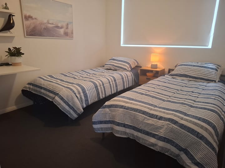 Two single beds plus small desk and wardrobe.
Quiet room with access to adjacent bathroom.