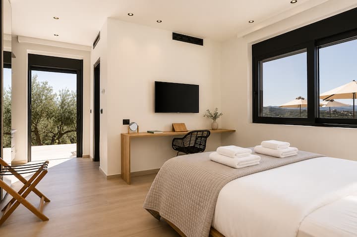 Ground Floor - Bedroom 1 - King-size bed, ensuite bathroom with walk-in shower, and direct access to the pool terrace