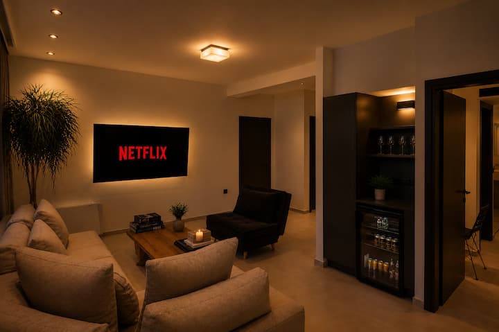 Lower Floor - A stylish private retreat - Cozy TV & Play Room featuring a 65" Smart TV, minibar, board games, and a comfortable lounge area for relaxing movie nights
