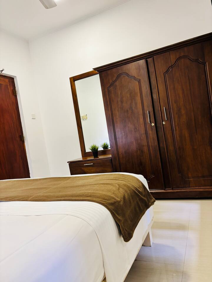 Bedroom with ensuite bathroom and hot-water shower.