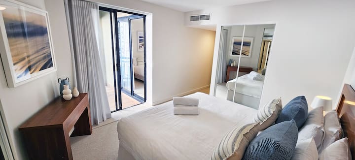 Main bedroom - King sized bed.  Built-in wardrobes, shared balcony with second bedroom + ducted air conditioning