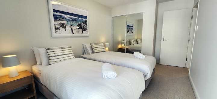 Second bedroom with 2 x king single beds, built-in wardrobes and a shared balcony with main bedroom. Ducted air conditioning. Twin beds can be turned into a King bed.