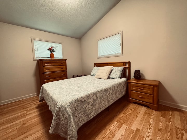 Cozy queen bedroom with sunny charm, closet space, and a dresser for your things. Opens to the half bath. Bobcat Room