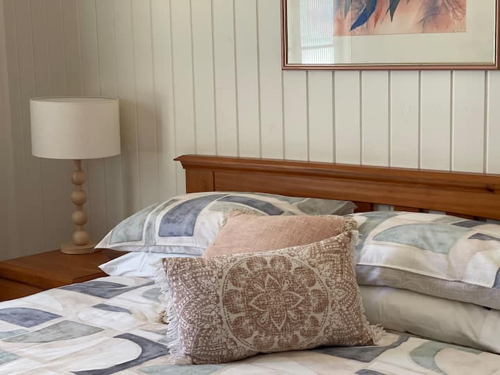 Queen sized comfortable bed with lovely linens, wardrobe, and air conditioning 