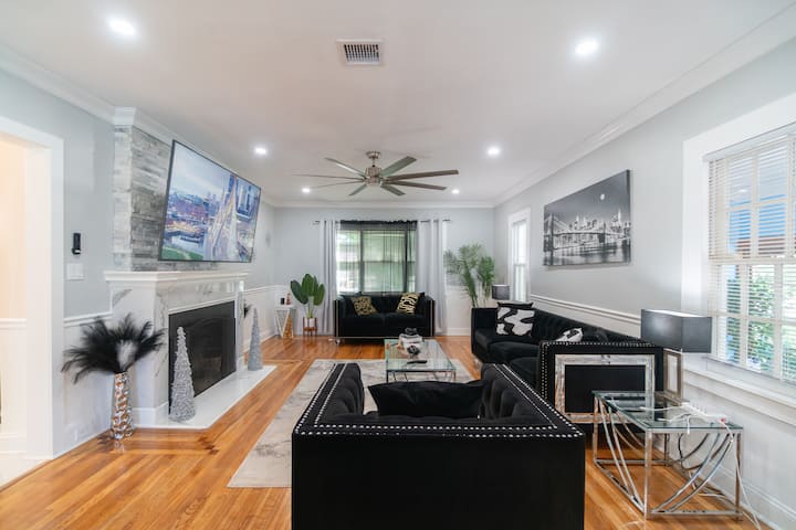 Step into pure sophistication.  This high-end space boasts lavish tufted velvet, a striking marble fireplace, and a massive screen for a cinematic escape. A flawless blend of elite comfort and modern opulence.