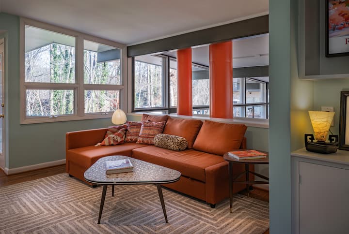 Loft overlooks living room and sectional sofa converts into a queen size bed for additional guests.