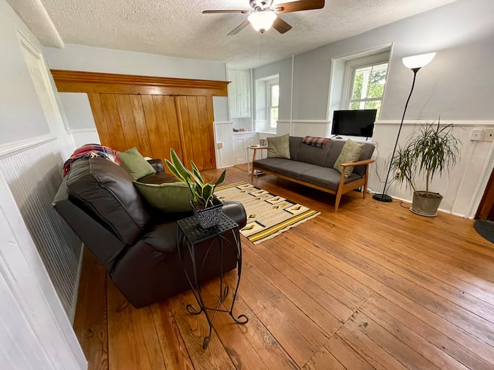 Living room. The couch on the right is a futon. Sheets are found in the wall cabinet.  Remember, there is a selection of games, dice, and cards in the wall cabinet as well.
