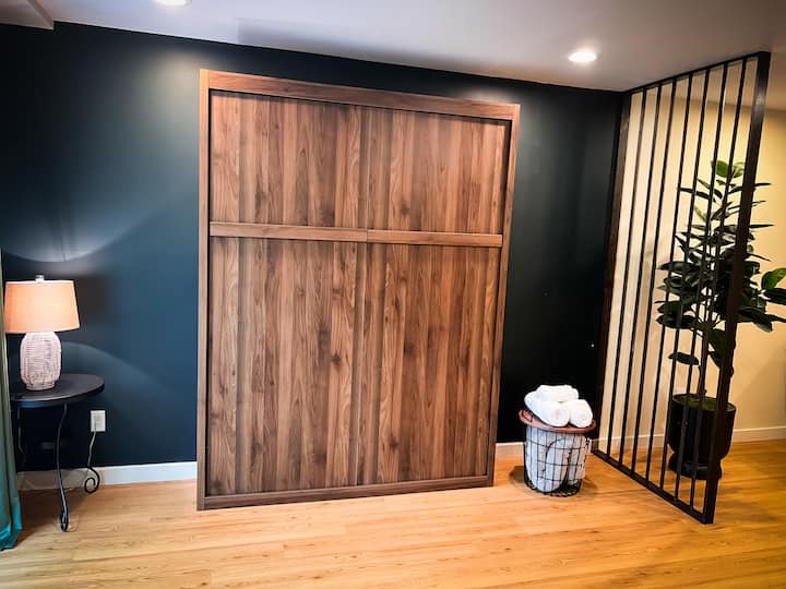 Comfortable queen size pull-down wall bed with a beautiful view of the forest.  