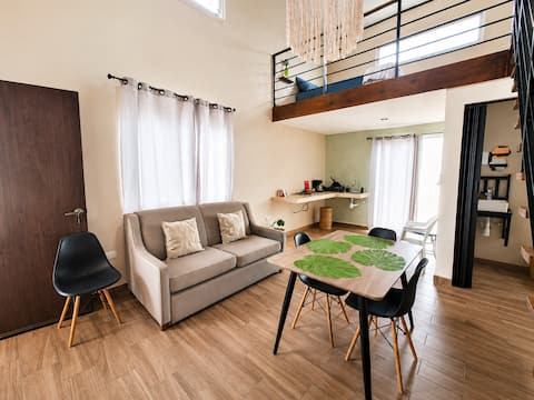 Top performing Airbnb: Double-height loft with pool 6 min from airport in Fraccionamiento Sian Kaan Iv