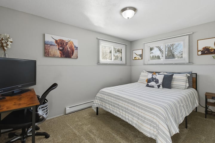 Comfortable bedroom with soft bedding, natural light, and peaceful western-inspired decor. A cozy, quiet space designed to help you relax and get a great night’s sleep.