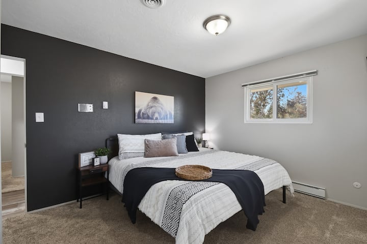 Master Bedroom with King Bed a comfortable bed, soft linens, and calming decor. The peaceful space & natural light create the perfect place to rest & recharge after a day exploring Great Falls..  Attached to main level bathroom.  55” Roku Enabled TV