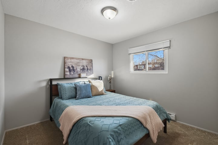 Cozy bedroom with a comfortable bed, soft linens, and calming tones. A quiet, inviting space designed to help you relax, unwind, and enjoy a restful night’s sleep during your stay.