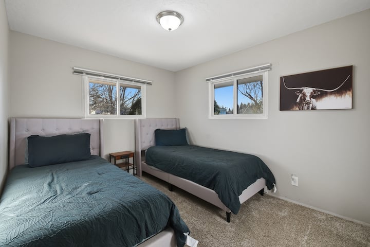 Comfortable bedroom with two single cozy beds, soft linens, and plenty of natural light. Perfect for families, kids, or friends traveling together, offering a relaxing and peaceful place to rest.