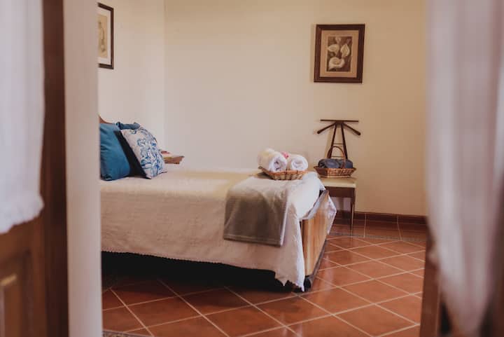 חדר עם מיטה זוגית ונוף יפהפה לגינה הפנימית.