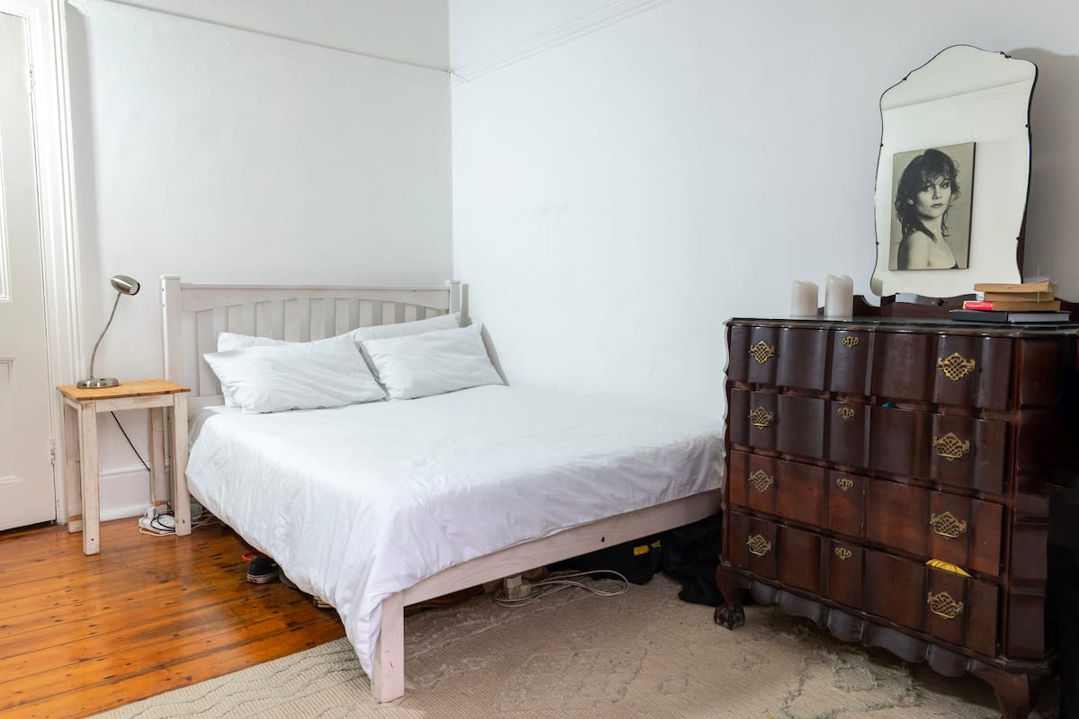 Double bed in the poolside room at Utopia co-living in Fresnaye, Cape Town