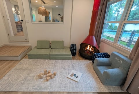 Sunroom — children's play area with electric fireplace