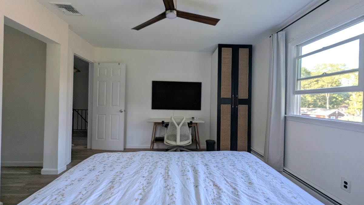 Bedroom 2 with king bed, workspace and TV
