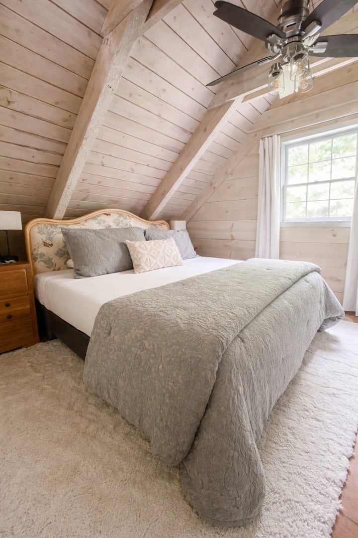 Upstairs bedroom.  King sized bed, blackout curtains, additional pillows and blankets available.