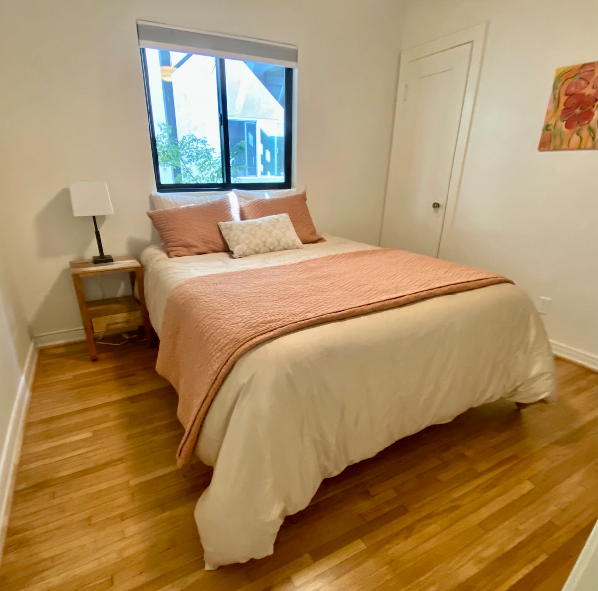 Second bedroom with queen sized bed and closet.