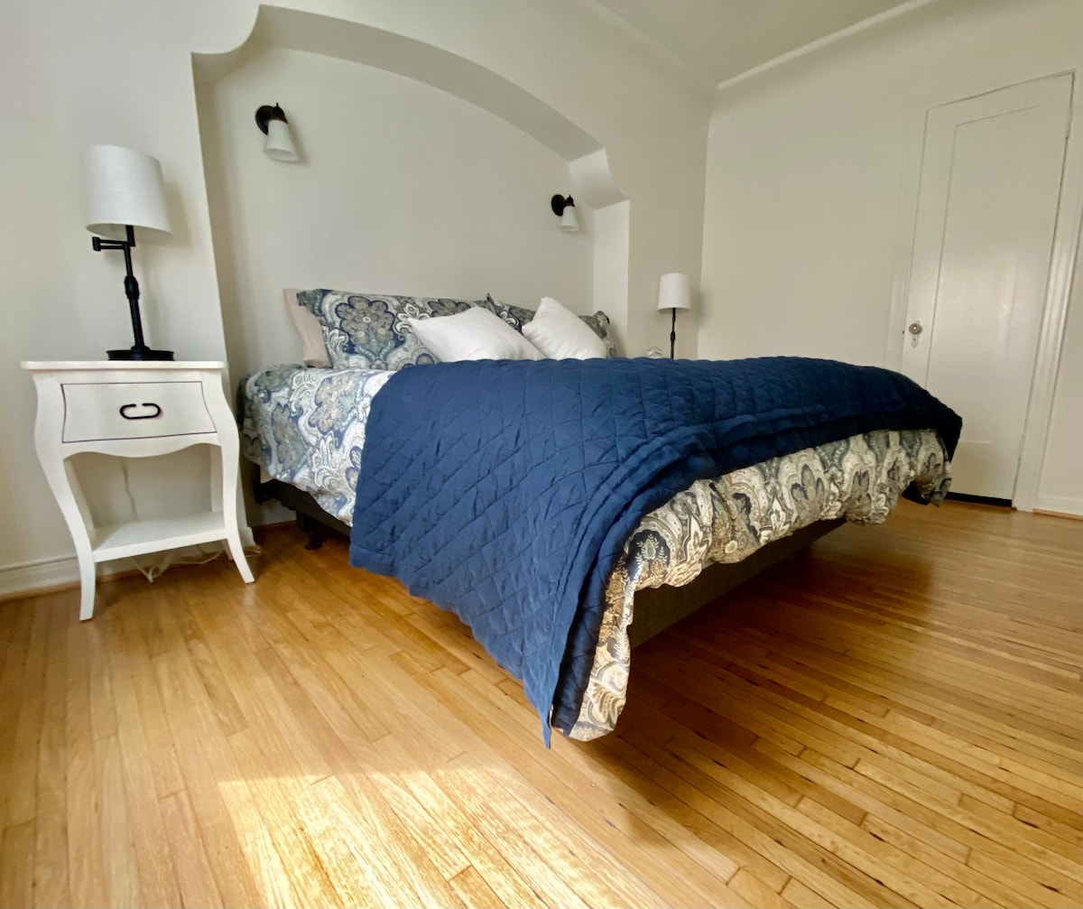 Master bedroom with a king sized bed and two full closets.