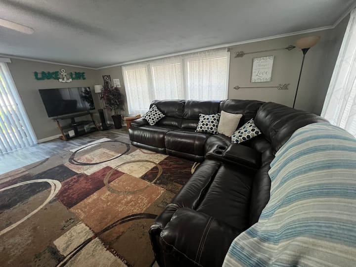 So many windows for beautiful natural light! Sectional pictured here as well as large sofa. TV with Fire-stick to access all your favorite apps. Lots of games, dominos, checkers, chess, and coloring books too. 