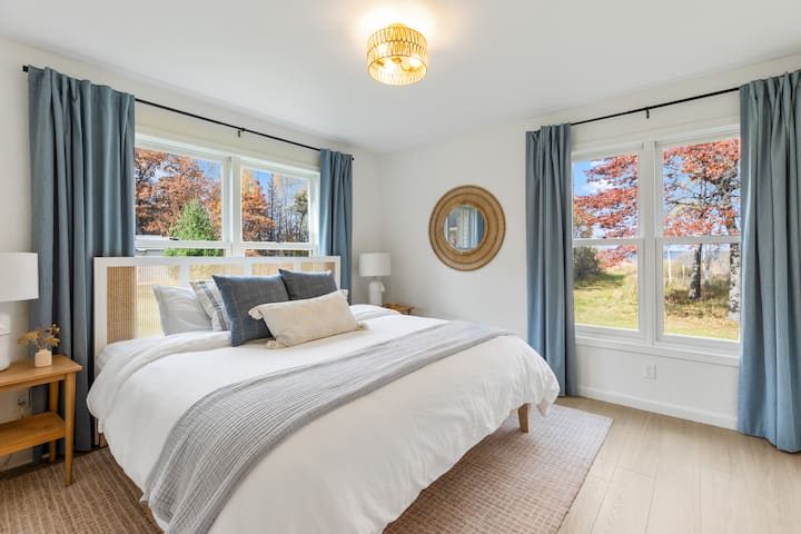 Cozy King bedroom with all the views and blackout curtains. closet with hangers, blackout curtains  ( changed from queen to king Sept 2025)