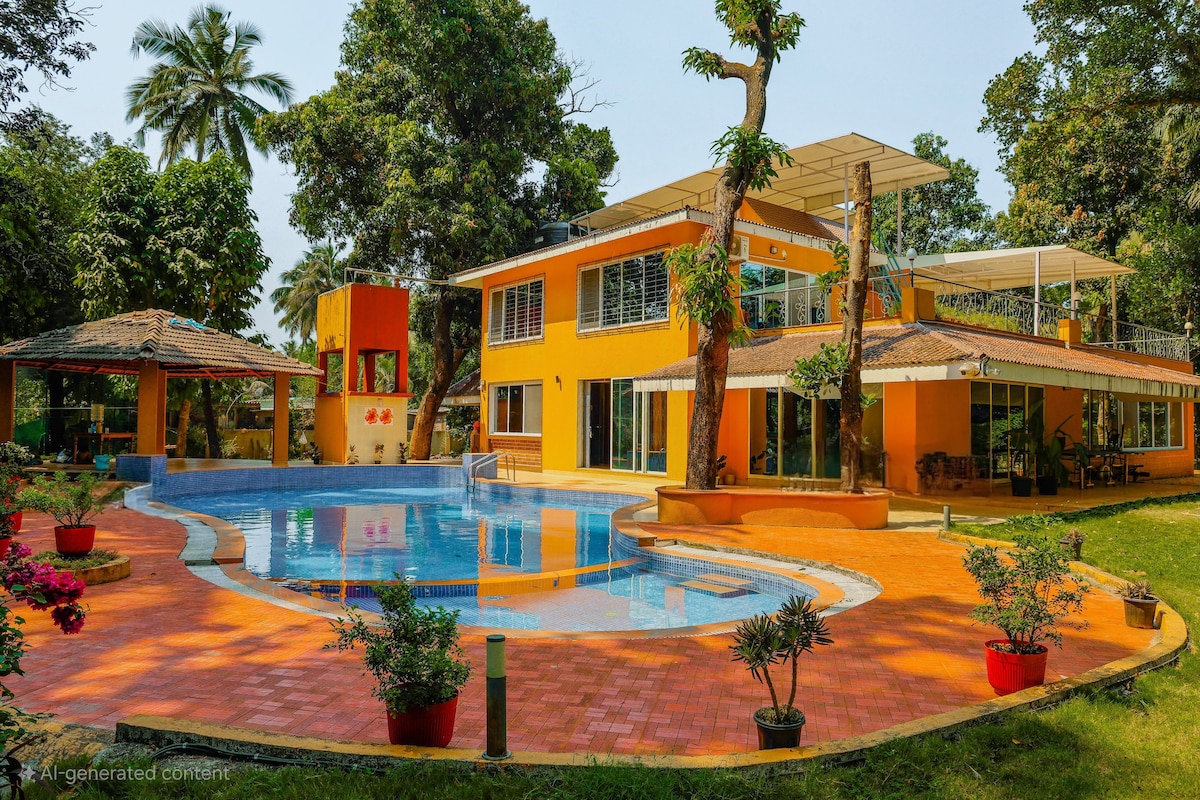 A vibrant villa exterior is shown, featuring a large swimming pool surrounded by a well-kept lawn. The two-story building with yellow walls is complemented by outdoor seating areas and lush greenery. Potted plants add color to the poolside patio.