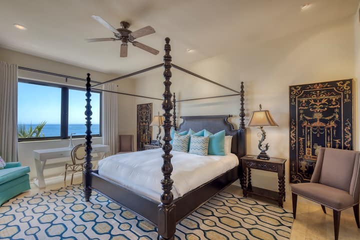 Sink into crisp white linens and wake to the calming blues of the ocean beyond your window—where elegance meets ultimate relaxation.