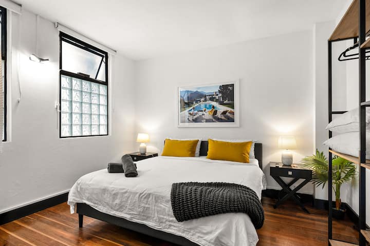 Bedroom 1 is the first master bedroom located on the ground level. It has a comfortable king bed, 55" frame TV, lotsof natural light, and a luxurious ensuite. It also gives stair-free access to the ground level kitchen and living spaces.