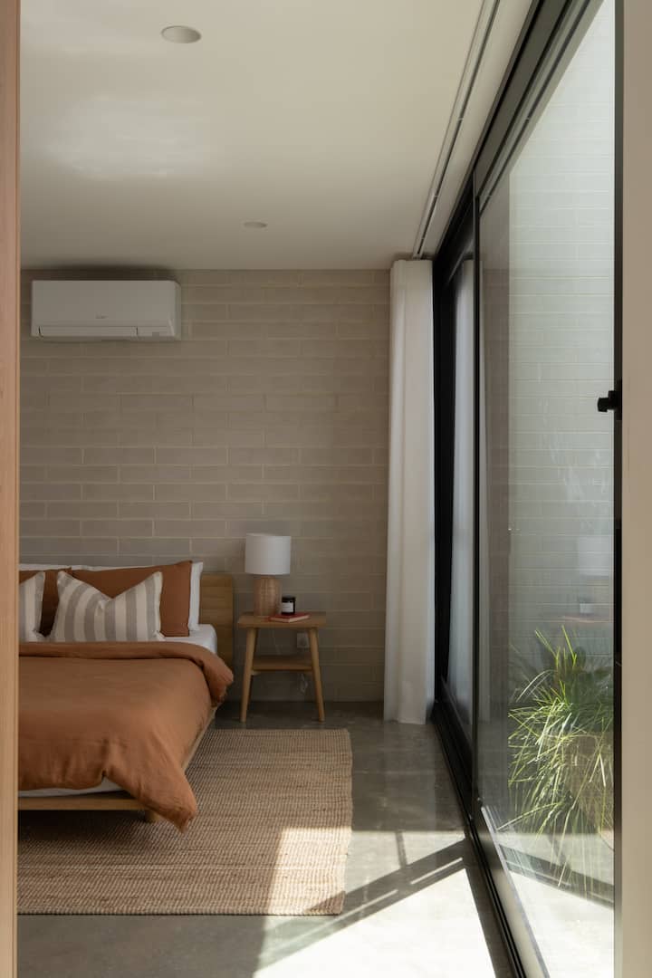 A delightful queen bedroom located on the ground floor. Each bedroom is fitted with it's own independent heating and cooling unit and built in wardrobes.