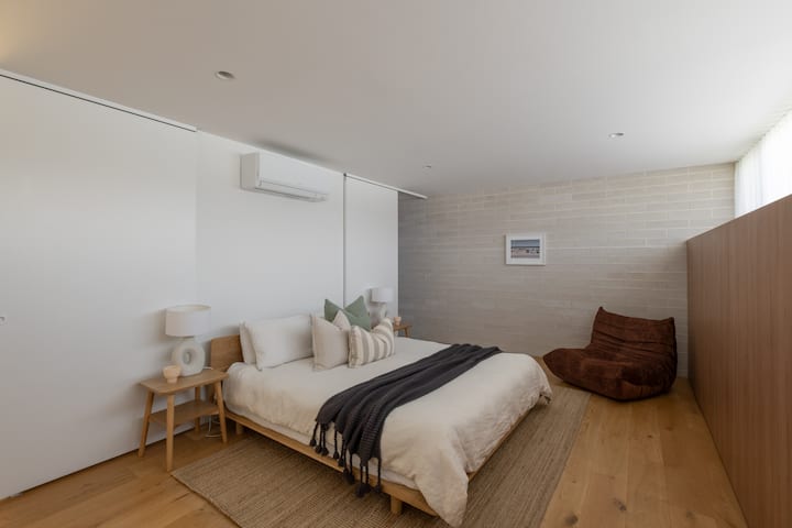 On the first floor is the spacious master suite with a king size bed, built in wardrobes and private ensuite bathroom. Calm, luxurious and inviting with cotton bedding and Totem Road furniture.