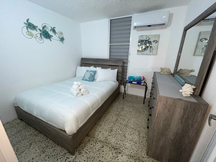 Second bedroom with queen bed and sea turtle décor