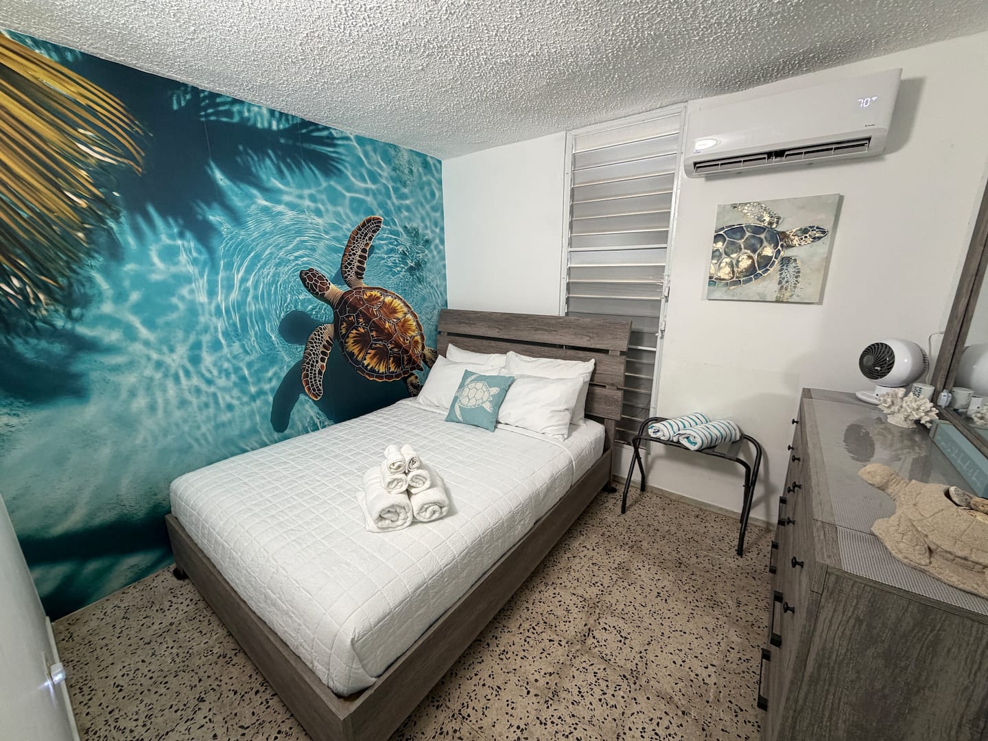 Turtle Room with queen bed and sea turtle mural at Tropical Enchant