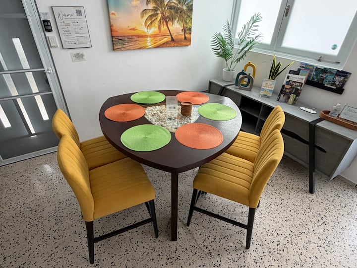 Dining area at Tropical Enchant with round dining table and tropical decor