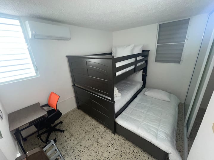 Bunkbed room with pull-out bed and desk at Tropical Enchant