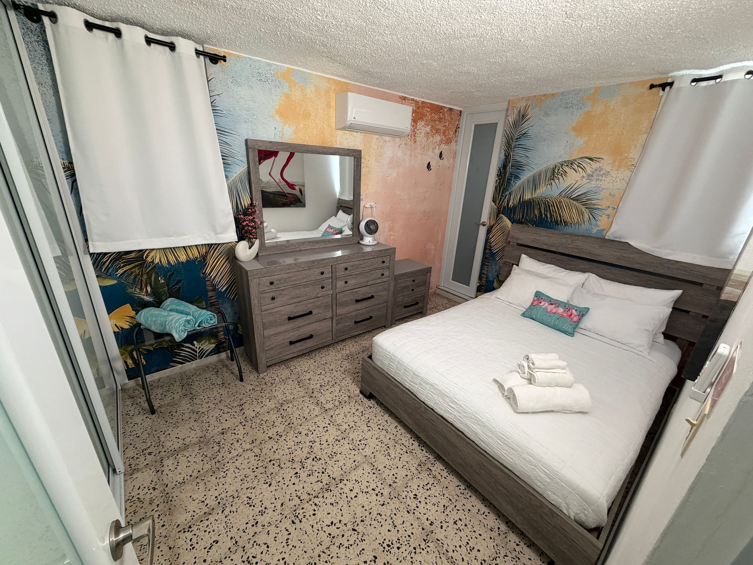 Flamingo Room with queen bed and tropical decor at Tropical Enchant