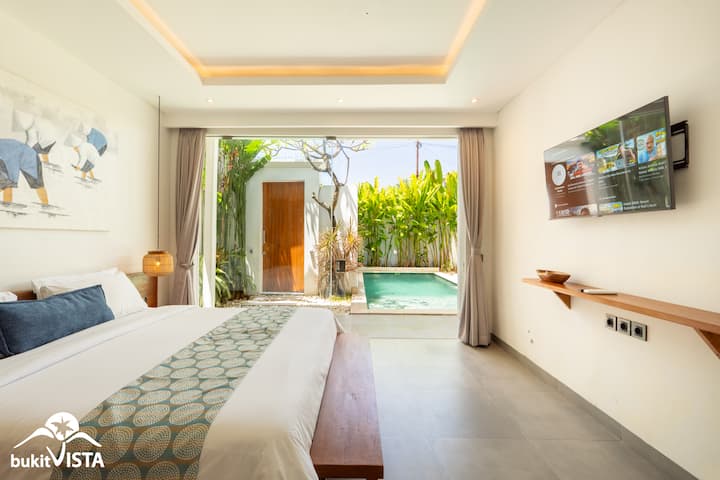 Bedroom with a comfortable queen-sized bed for a more spacious and restful sleep with a direct view of the inviting pool area.
