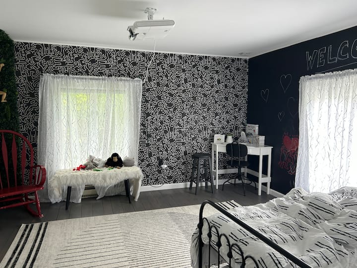  The Haring- kids room with green wall, chalkboard wall, funky wallpaper, and tons of toys Awesome kids room with trundle bed for additional sleeping