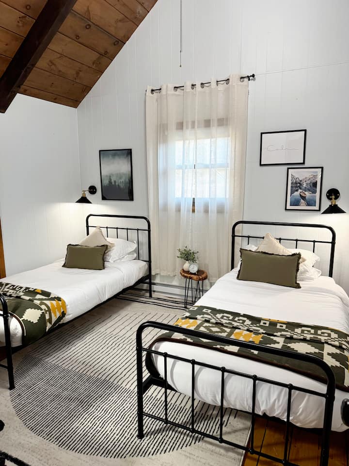 Spacious room vaulted ceilings, large closet space and single beds. 

Also includes a designated work space, desk with high-speed internet. 