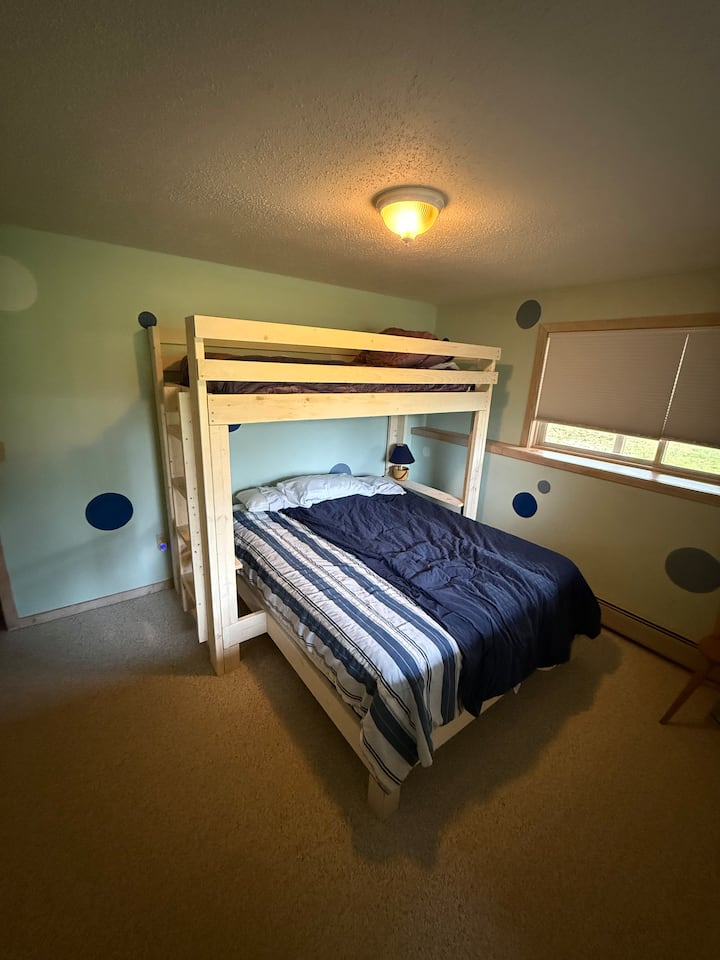 Queensize-säng längst ner med en enkelsäng ovanpå