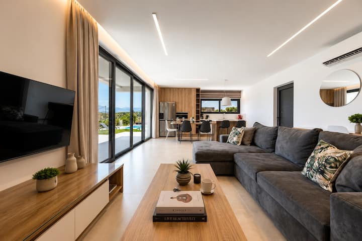 Ground Level - Bright open-plan living & dining area with comfortable seating, perfect for relaxing and spending quality time together