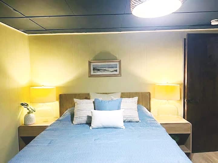 Queen bed with fan on lower level