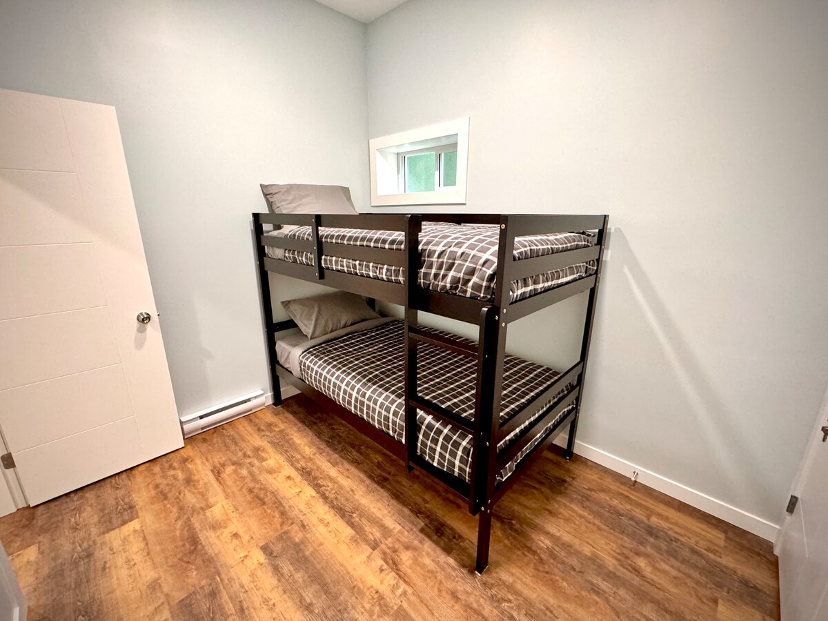 Downstairs bunk room with twin beds—perfect for kids or extra guests to rest after a day by the lake.