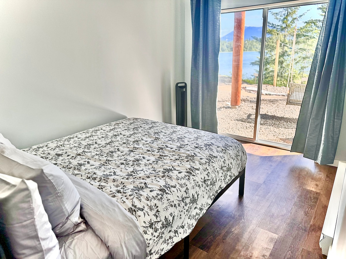 Downstairs queen bedroom with walkout access and lake views—wake up to nature just steps from the water.