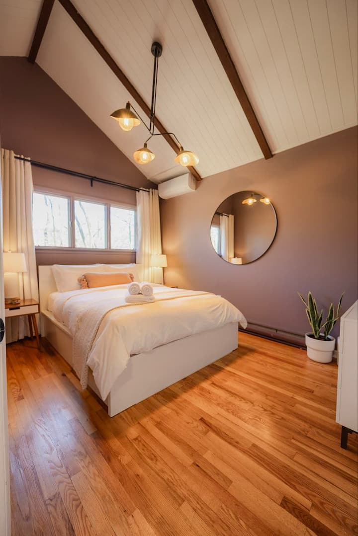 The second-floor bedroom with a cozy queen bed (IKEA mattress), closet, chest of drawers, and air purifier